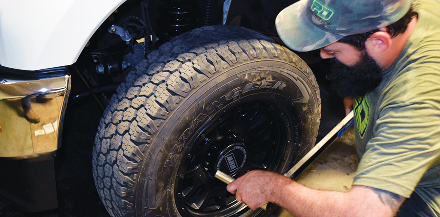 Step 7: Put Front End Back Together putting wheels on a truck
