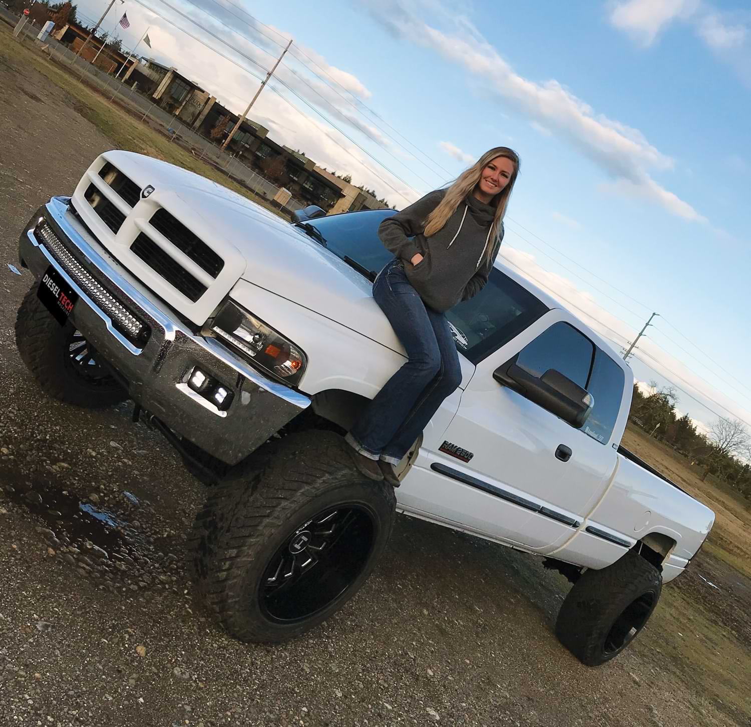 Kendall Reed sitting on the hood of her new truck