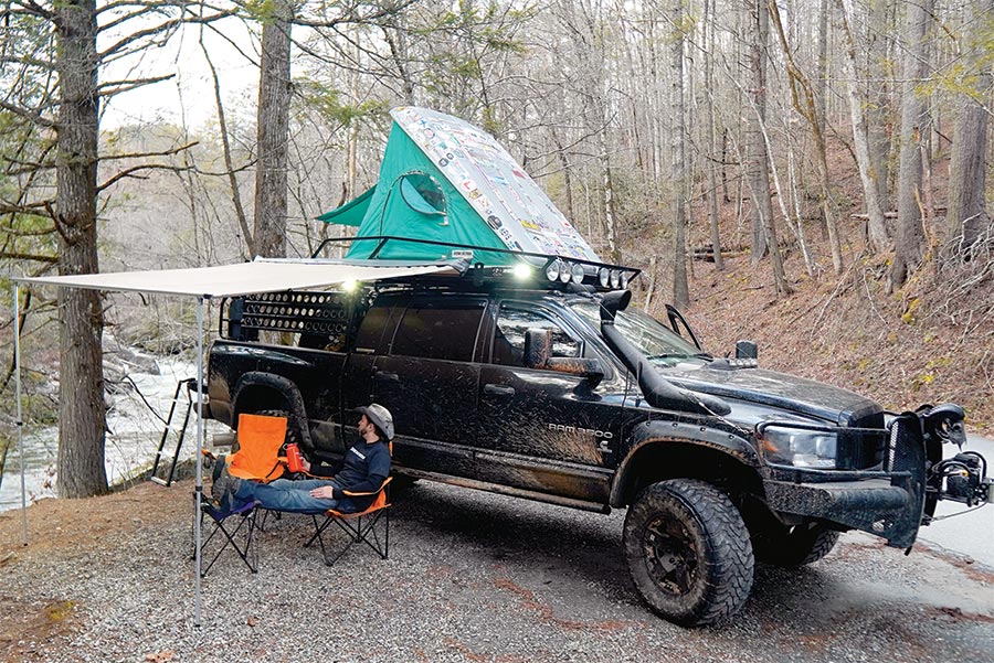 Ram 3500 parked with tent and shelter set up