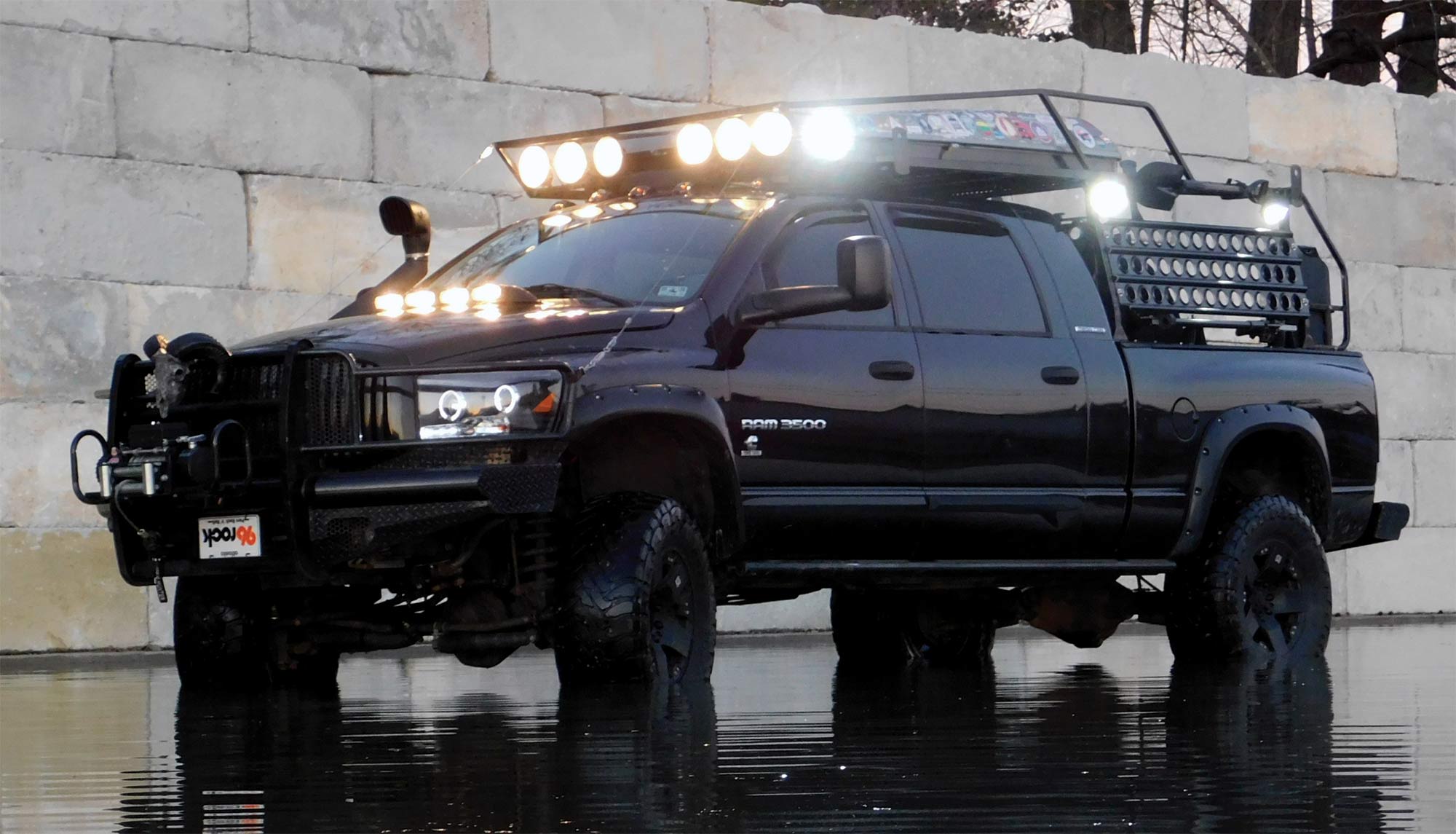 black Ram 3500 in the rain with headlights on