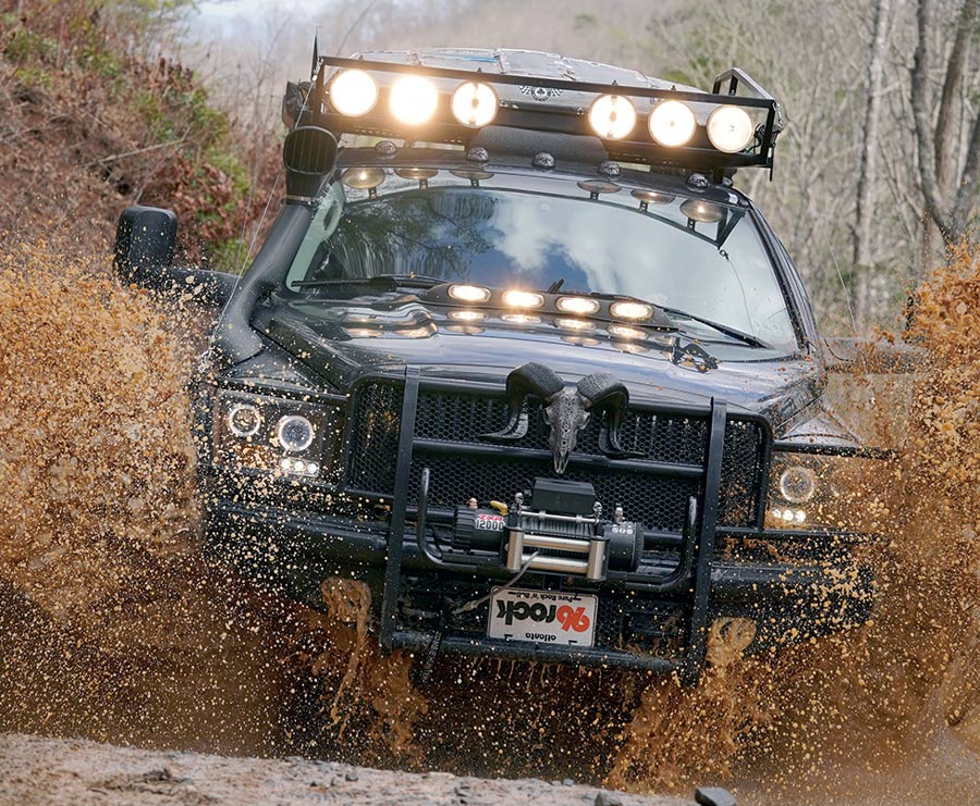 black truck driving through the mud