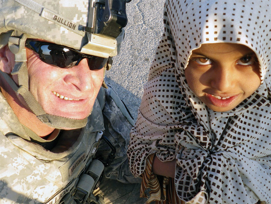 troop in uniform with little girl