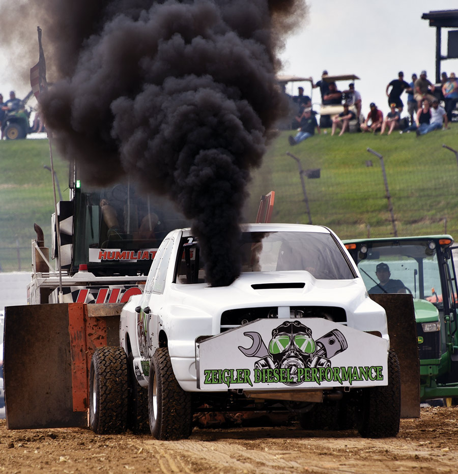 white car on the track blowing smoke