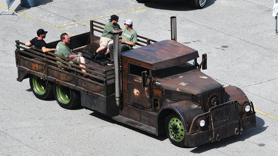 four people in the bed of a truck