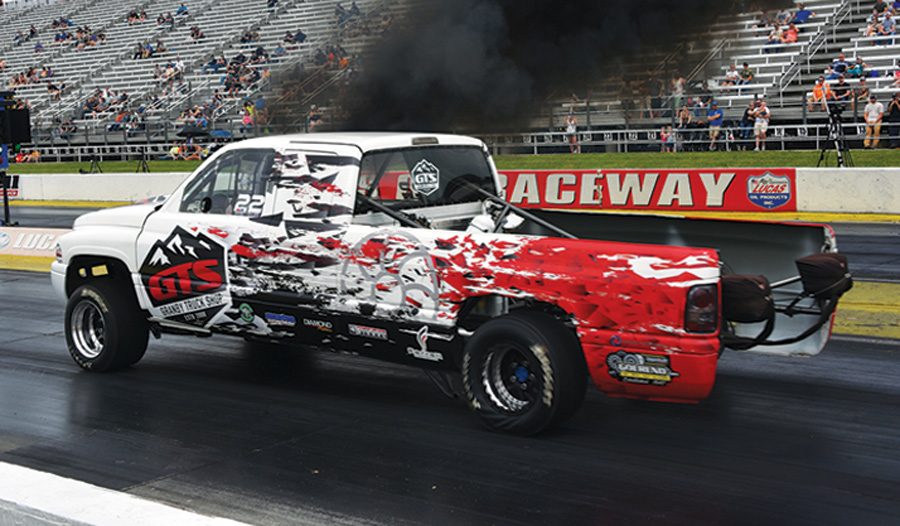 white truck with black and red decals racing