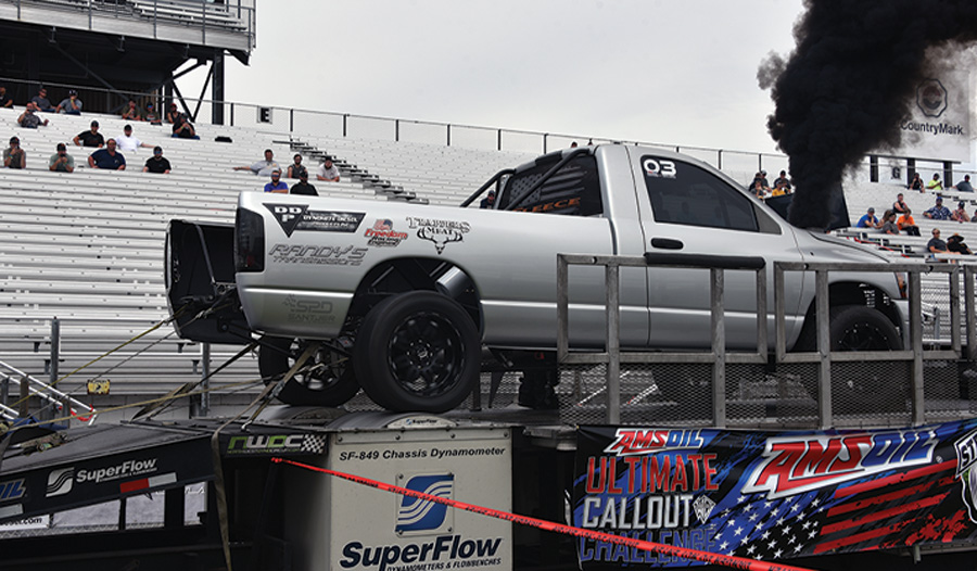 silver truck on the podium blowing smoke