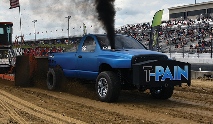 blue truck racing blowing smoke