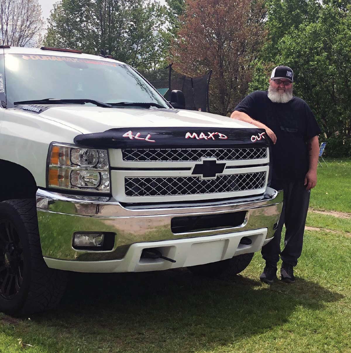 Jake next to his 2014 Chevy Silverado Man next to his truck