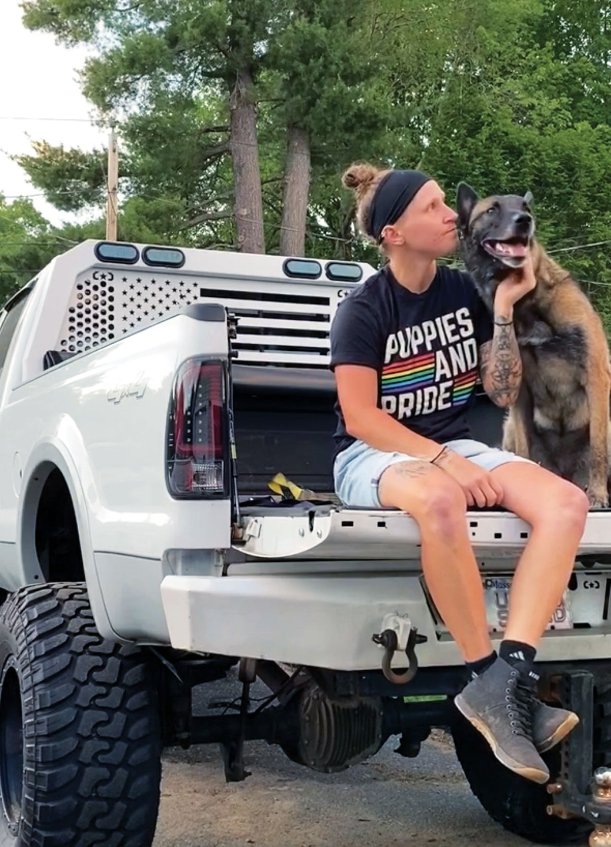 Courtney Craven sitting in the bed of her F350 with her dog