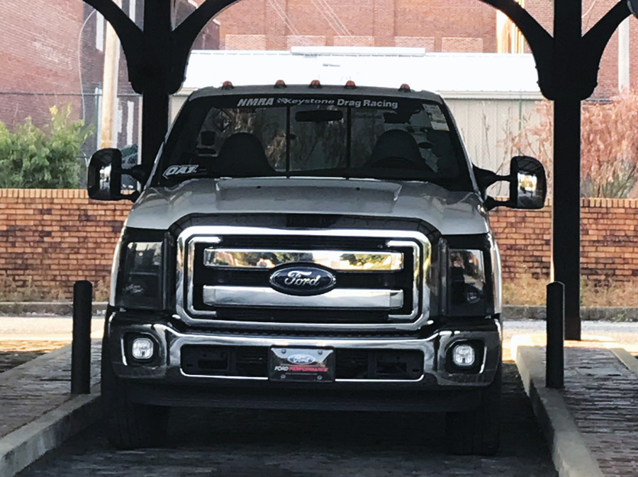 front of white Ford truck