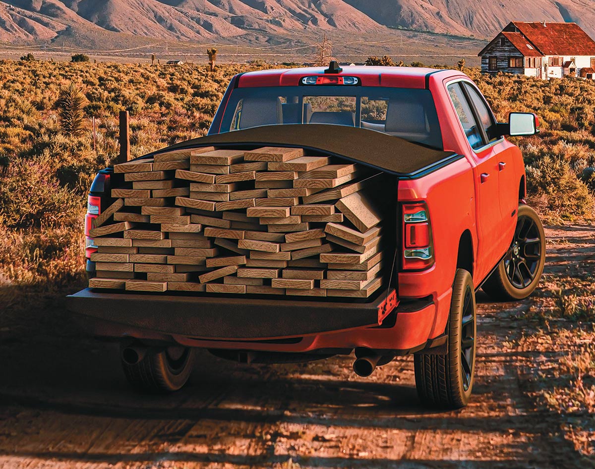 red truck with wood planks in bed trunk