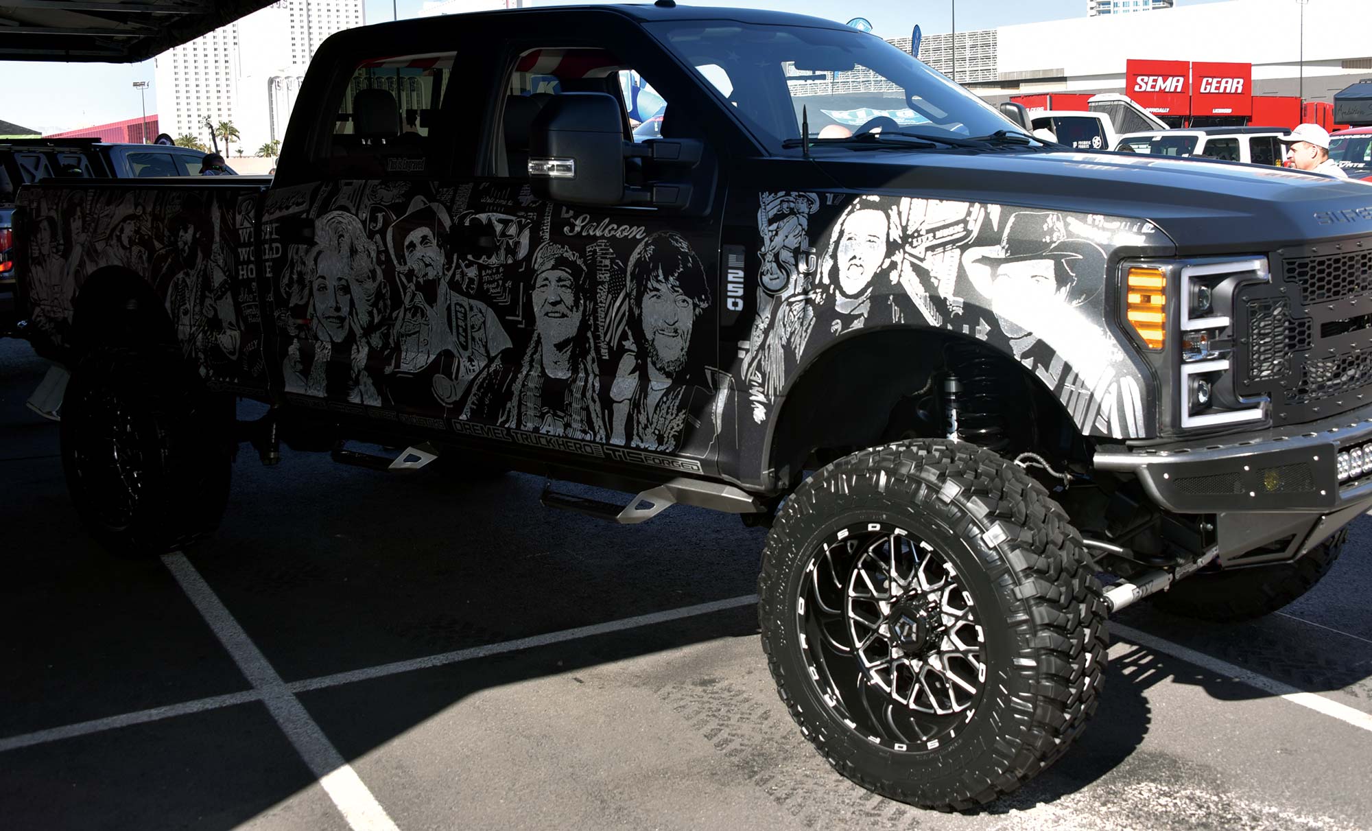 black truck with white decals of famous celebrities