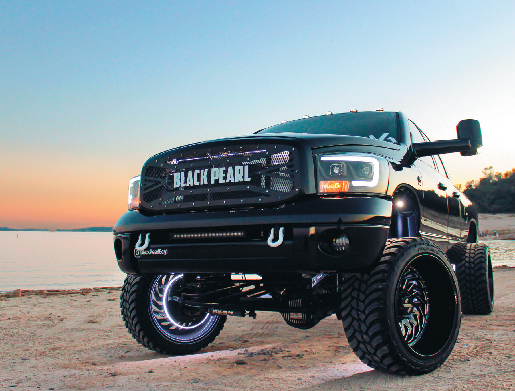lifted black truck at sunset