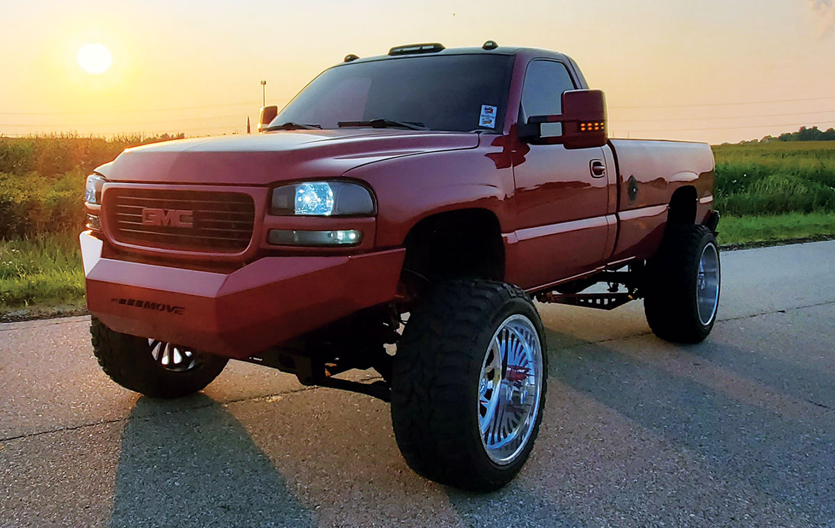 2002 GMC Sierra side profile against a soft orange sky