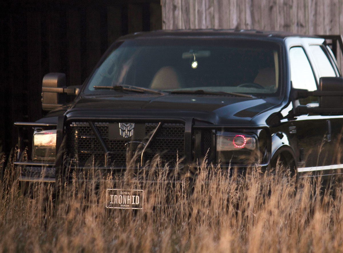 The Power of Pink 2001 F250 Power Stroke behind tall grass