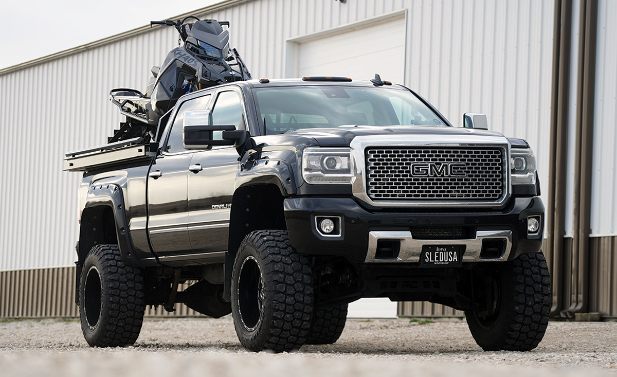 2015 GMC Sierra 2500 with snow mobile in bed of trunk