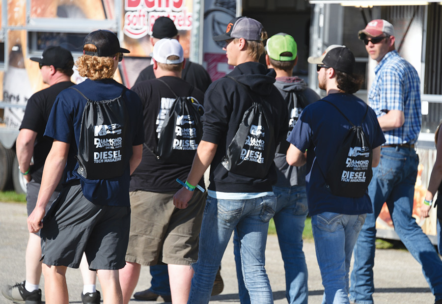 group of people walking at car show