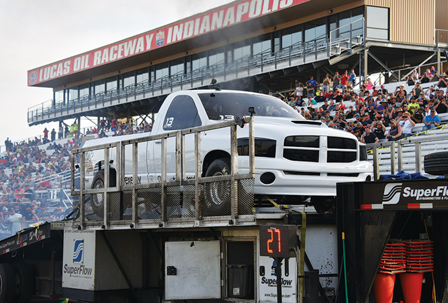 white truck on trailer at drag race
