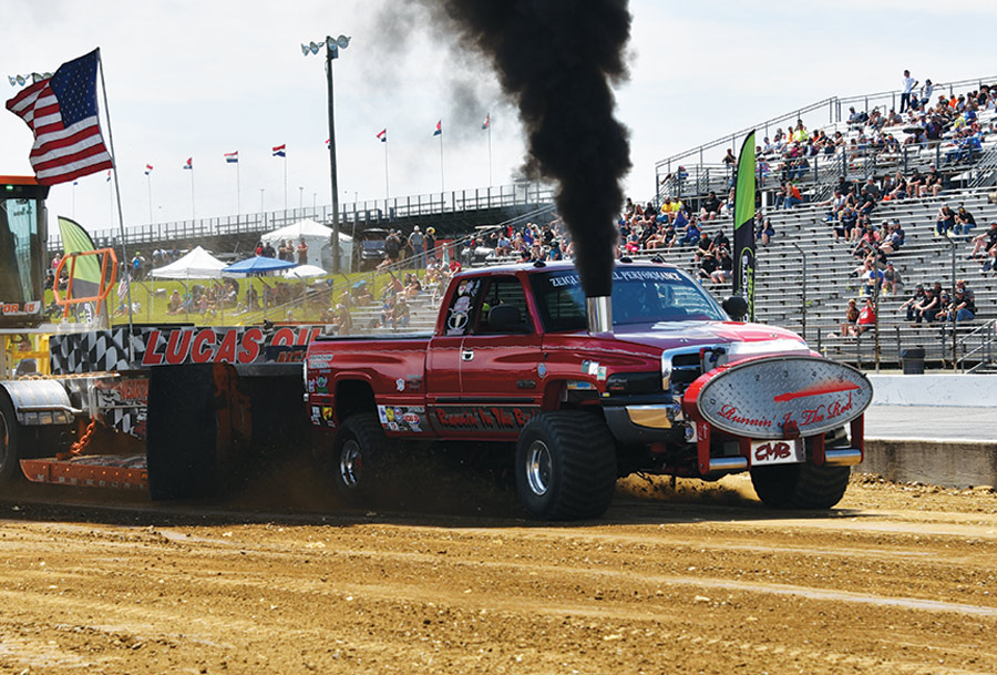 red truck in drag race on dirt