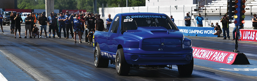 completely blue truck in a drag race during the daytime