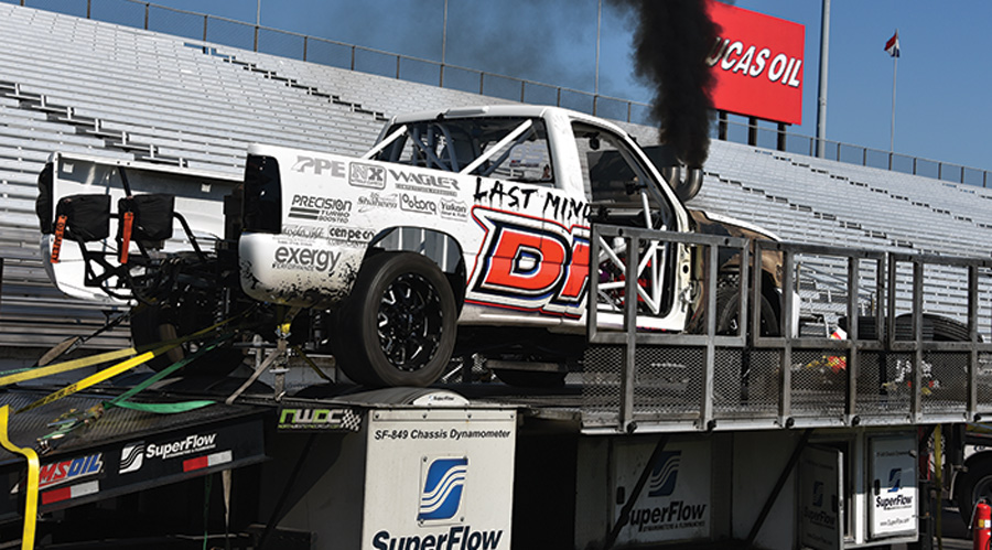 white truck on stage blowing smoke