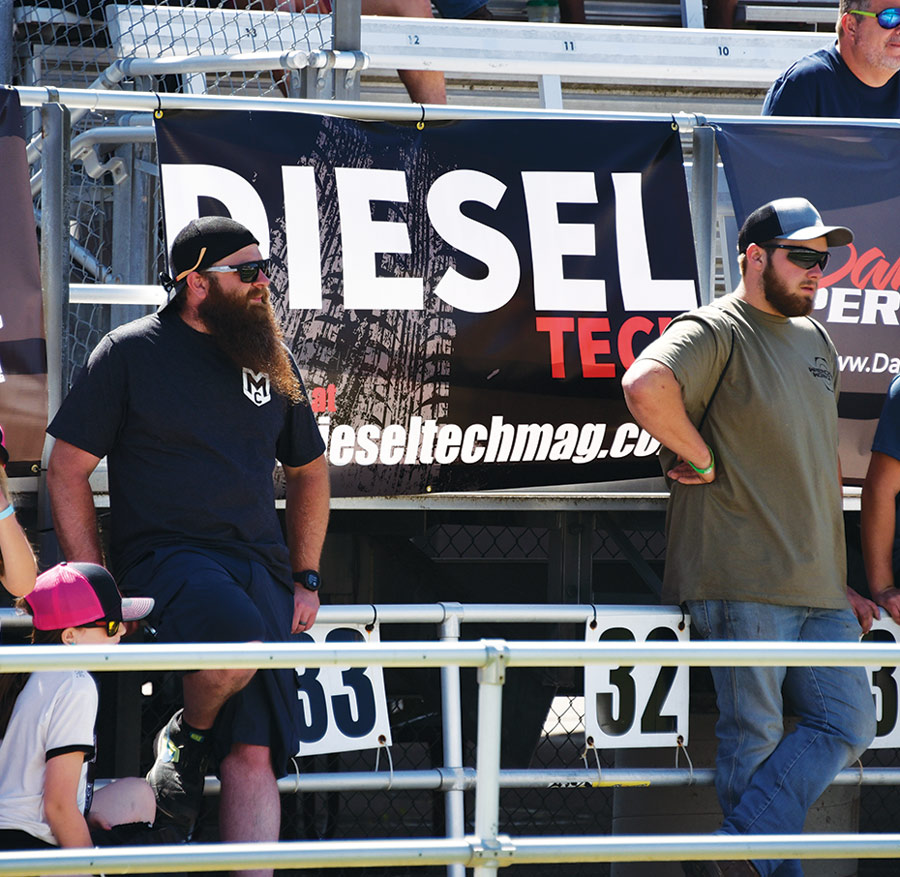 two men standing in the bleachers