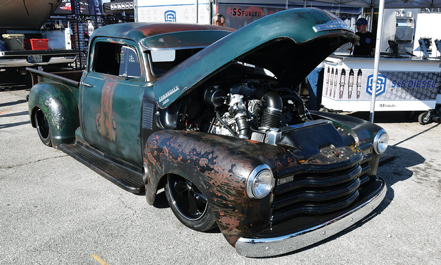 rusted green truck with hood open