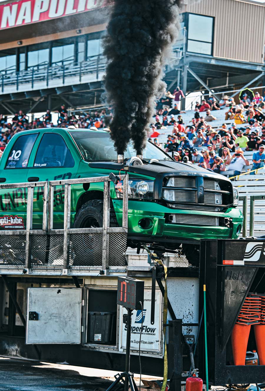 green truck on stage blowing smoke