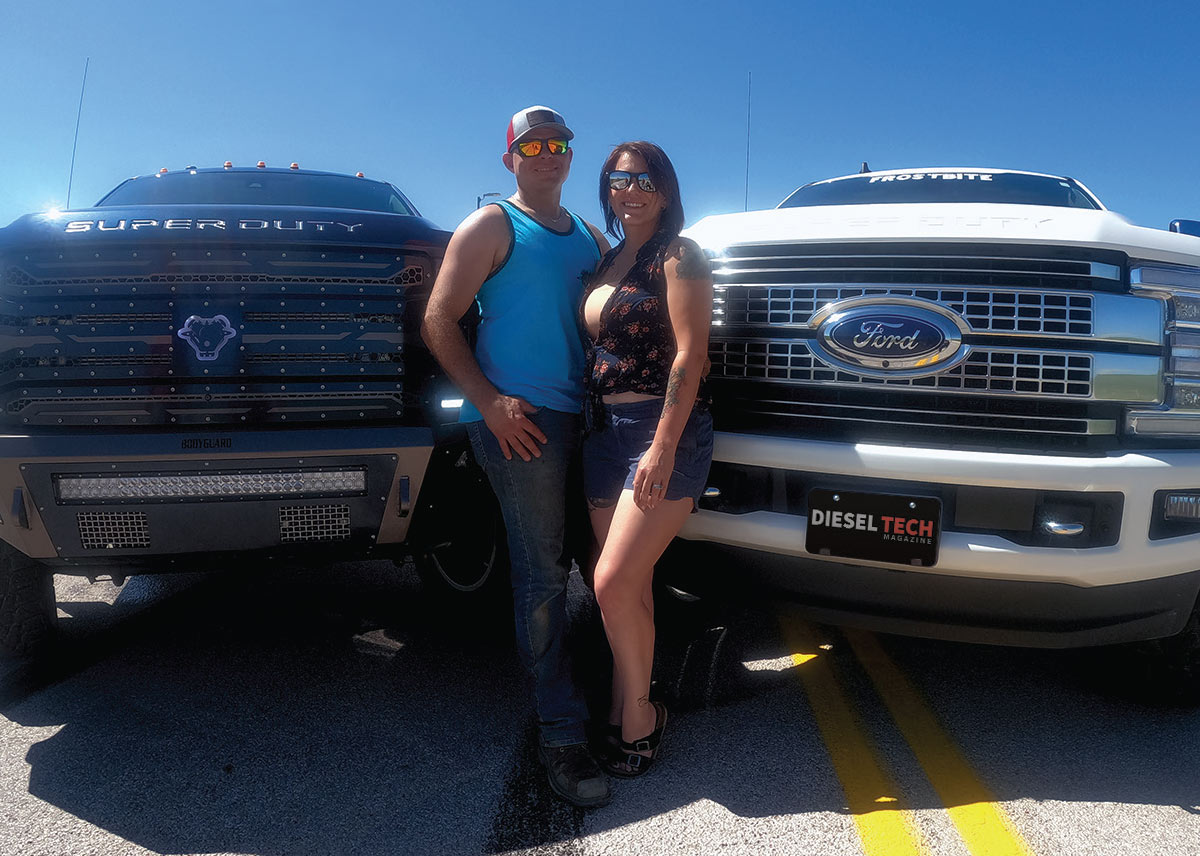 Couples in front of trucks