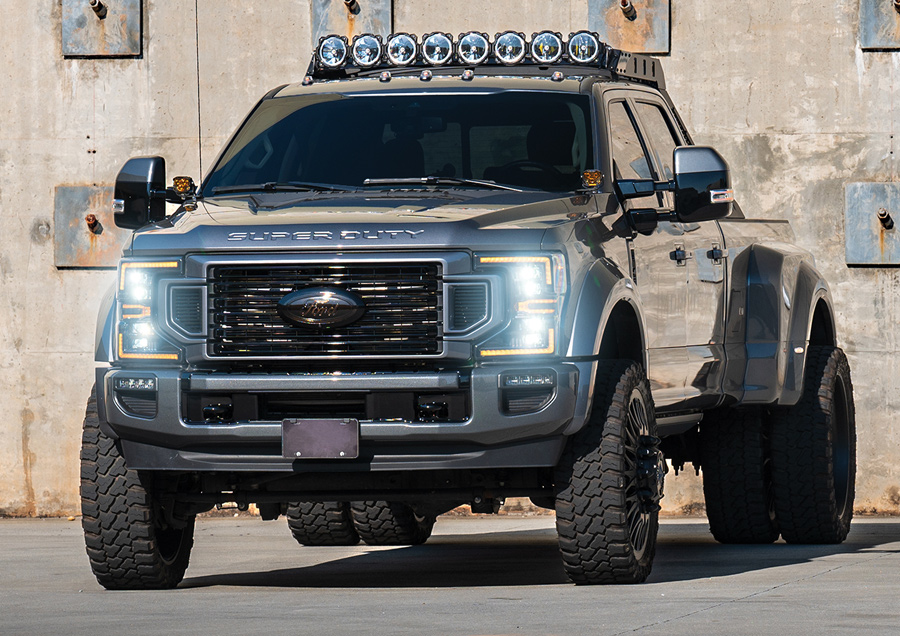 grill and front bumper view of truck with headlights on