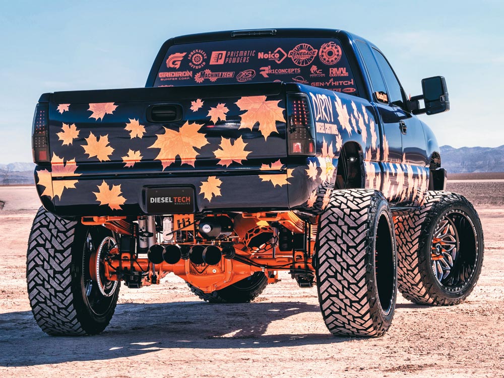 rear of blue and orange truck with autumn leaves decals