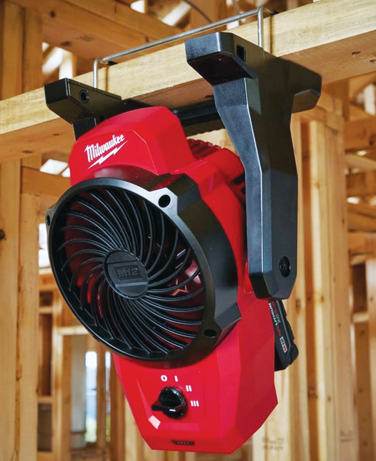 Milwaukee M12 Portable Fan mounted on a wooden beam