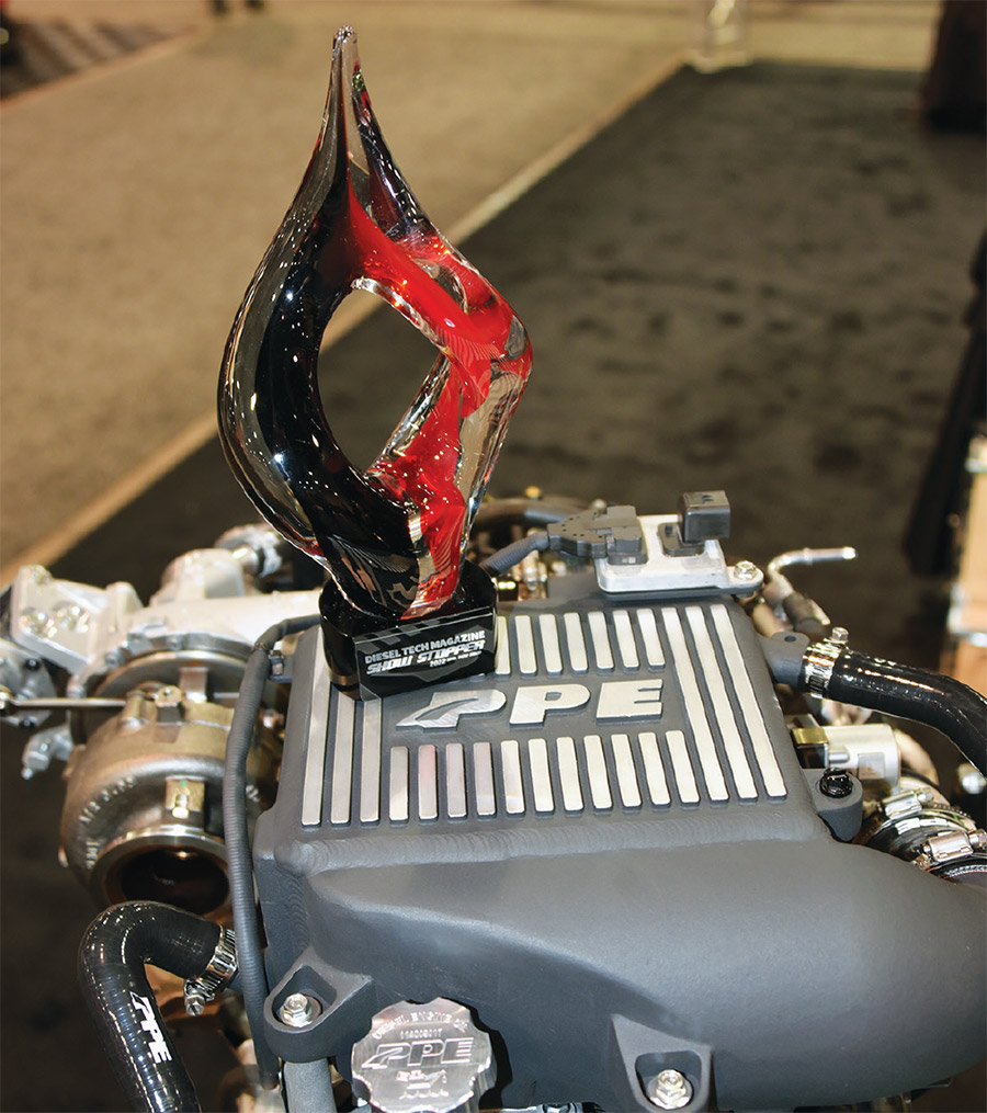 Diesel Tech Magazine 2022 Show Stopper Award sits on top of a Pacific Performance Engineering (PPE) intercooler kit (gray color) for the GM 3.0L LM2 duramax engine