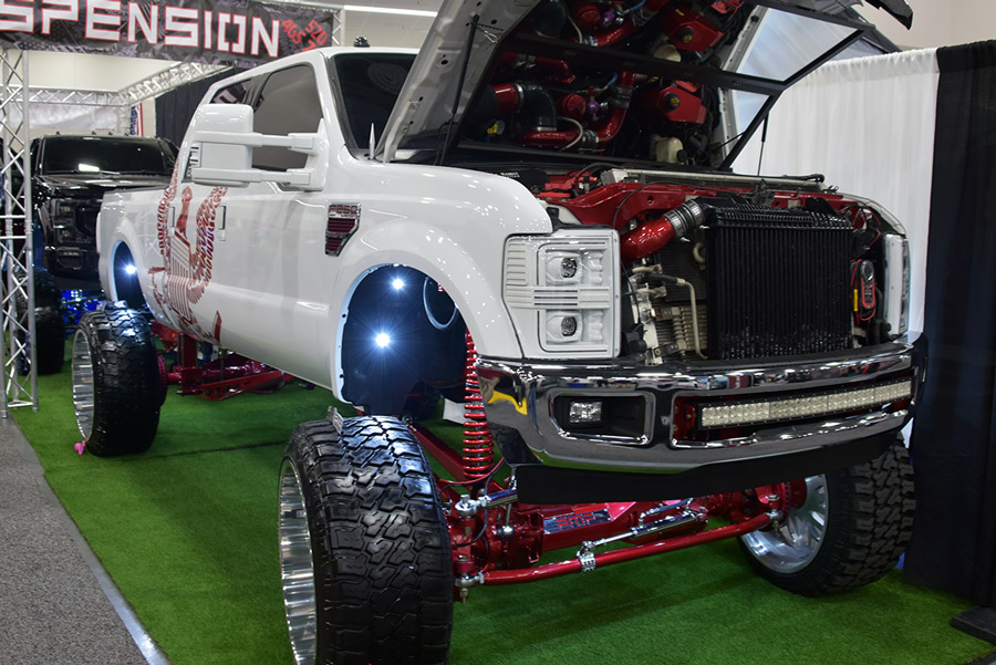 white truck with red trim and hood open