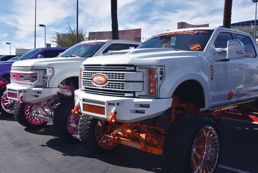 white truck with orange trim and white truck with pink trim