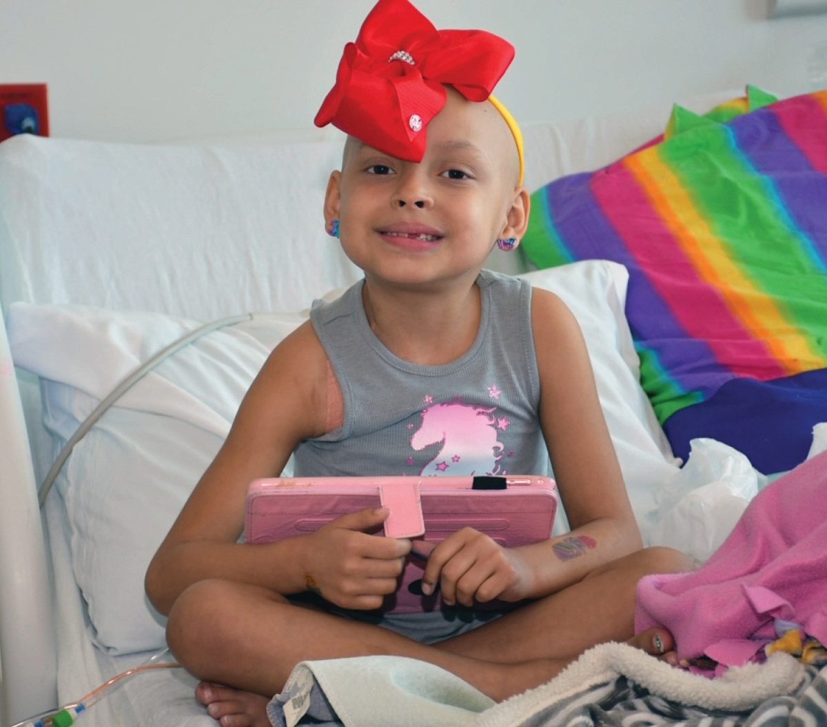 Zoe smiling on hospital bed
